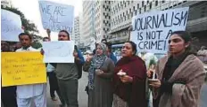  ?? AP ?? Activists hold a vigil to condemn kidnapping­s and violence against journalist­s in Karachi.