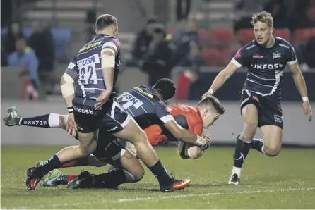  ??  ?? 2 Owen Farrell holds off a challenge from Sale winger Denny Solomona to score a try as Saracens cemented their grip on Pool 3.