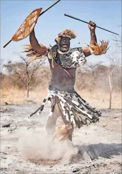  ?? Photo: Zinyange Auntony/afp ?? Tales of battle: A member of the king’s regiment gestures during the annual King Mzilikazi commemorat­ion on 9 September in Bulawayo, Zimbabwe.