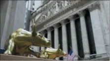  ?? MARY ALTAFFER — THE ASSOCIATED PRESS FILE ?? Replicas of Arturo Di Modica’s “Charging Bull” are for sale on a street vendor’s table outside the New York Stock Exchange in New York.