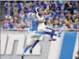  ?? Paul Sancya / Associated Press ?? Los Angeles’ Robert Woods, defended by Detroit’s Darius Slay, makes one of his five catches in the Rams’ 30-16 win over the Lions. The win clinches the NFC West and a playoff spot for the Rams.