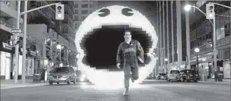  ?? Sony Pictures ?? JOSH GAD’S CHARACTER is chased by a giant Pac-Man in “Pixels,” which is expected to launch with up to $32 million in ticket sales.