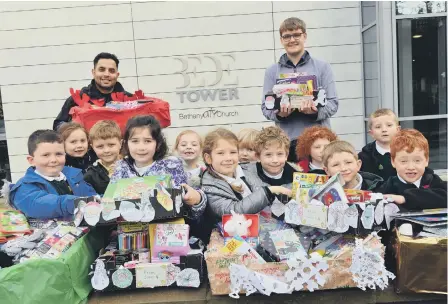  ??  ?? Hill View Infants made hamper donations to Bede Tower Global Cafe with refugee Miaad Hajianfar and assistant Pastor Daniel Alcock.