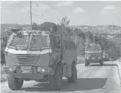  ?? JAAFAR ASHTIYEH/GETTY-AFP ?? Israeli military vehicles drive Saturday in Jenin in the occupied West Bank.