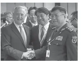  ?? AP Photo/Yong Teck Lim ?? ■ From left, U.S. Defense Secretary Jim Mattis, Japan’s Defense Minister Itsunori Onodera and China’s People’s Liberation Army’s Academy of Military Science Deputy President He Lei pose for photos at a ministeria­l roundtable on the sidelines of the...