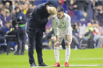  ?? AFP ?? Real Madrid coach Zinedine Zidane talks to Eden Hazard before the Belgian came off injured.