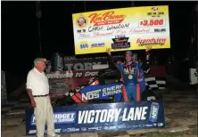  ?? RICH KEPNER - FOR MEDIANEWS GROUP ?? Chris Windom holds the winner’s check after winning the Ken Brenn USAC Midget Masters race during Thunder on the Hill racing at Grandview on July 30.