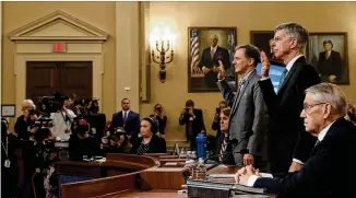  ?? DREW ANGERER / GETTY IMAGES ?? William Taylor, the highest-ranking U.S. official in Ukraine (standing right), and George Kent, a deputy assistant secretary at the State Department, are sworn in Wednesday at the Capitol prior to providing testimony in just the fourth public impeachmen­t hearings in the nation’s history. The two described confusion within the U.S. government and in Ukraine about what President Donald Trump wanted from Kyiv.