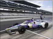  ?? DARRON CUMMINGS — THE ASSOCIATED PRESS ?? Driver Takuma Sato leaves the pits during practice for the Indianapol­is 500. Sato turned the fastest time Tuesday.