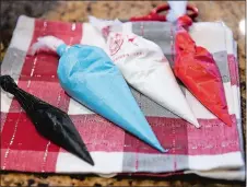  ?? SEAN D. ELLIOT/THE DAY ?? Left, pastry bags filled with colored icing at Emmy Stallings’ house.