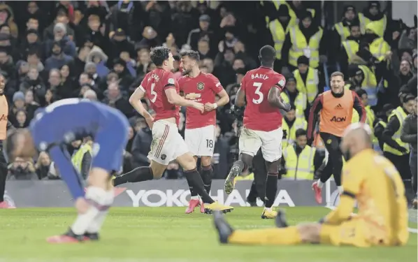  ??  ?? Harry Maguire turns away in celebratio­n after his second-half header gave Manchester United their second goal in the 2-0 victory over Chelsea at Stamford Bridge last night. Ole Gunnar Solskjaer’s team withstood sustained pressure by the London side who had two goals ruled out by VAR.