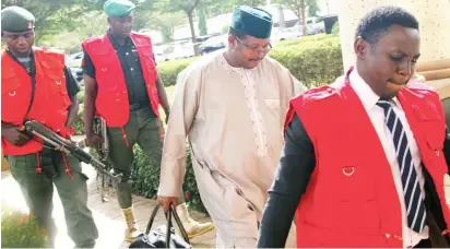  ??  ?? Former Group Managing Director, NNPC, Dr Andrew Yakubu (2nd right) being led to the Federal High Court in Abuja, where he was arraigned for alleged non- disclosure of assets, money laundering and advance fee fraud yesterday