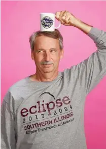  ??  ?? Randy Johnson, of 710 Bookstore, has sold more than 600 eclipse T-shirts, hats and coffee mugs.