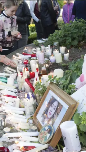  ??  ?? Candles were lit at the vigil in Enniskerry last week.