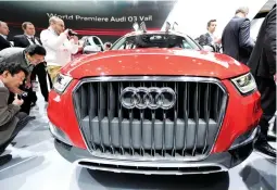  ??  ?? Media personnel get a close-up view of the Audi Q3 Vail during the recent North American Internatio­nal Auto Show in Detroit, Michigan. (Reuters)