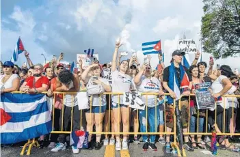  ?? CHANDAN KHANNA/GETTY-AFP ?? People protest Wednesday in Miami to show support for Cubans demonstrat­ing against their government.