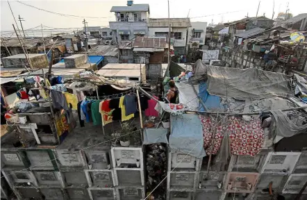  ?? — Filepic/aFP ?? Reality bites: To tackle a more substantiv­e agenda for a truly new normal, congested slums that have become fast lanes for Covid-19 in Manila must be addressed.