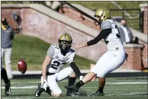  ?? L.G. PATTERSON — THE ASSOCIATED PRESS FILE ?? In this Nov. 28, 2020, photo, Vanderbilt’s Sarah Fuller, right, kicks off as Ryan McCord (27) holds to start the second half of an NCAA football game against Missouri in Columbia, Mo. With the kick, Fuller became the first female to play in a SEC football game.