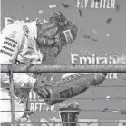  ?? JEROME MIRON/USA TODAY SPORTS ?? Lewis Hamilton is sprayed with champagne after winning his sixth F1 world title.