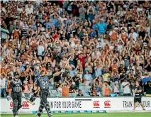  ?? PHOTOSPORT ?? Fans in the crowd during the T20 match between the Black Caps and Australia at Eden Park last Friday.