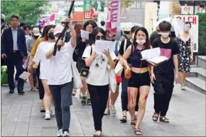 ?? JUNG YEON-JE/AFP ?? South Korean women participat­e in a protest to urge tech giants to work harder to curb high-tech sex crimes in Seoul, on August 18.