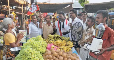  ?? ?? AIADMK PARTY WORKERS campaign with poll promises of free mixer-grinders and fans at Srirangam constituen­cy, in Tiruchi in April 2011.