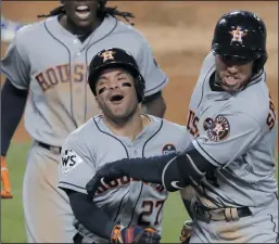  ?? AP PHOTO ALEX GALLARDO ?? Houston Astros’ George Springer celebrates with Jose Altuve after hitting a two-run home run during the 11th inning of Game 2 of baseball’s World Series against the Los Angeles Dodgers Wednesday in Los Angeles.