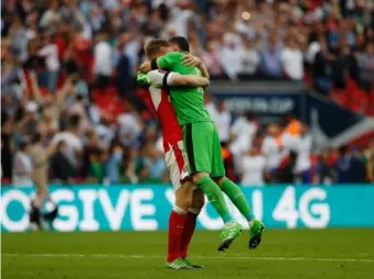  ??  ?? Mertesacke­r and Ospina embraced at full time (Getty)