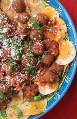  ?? Tribune News Service ?? ■ Nachos with meatballs features two crowd-pleasers packed as one hearty snack. Pork meatballs are dunked into a chunky salsa and served on cheesy tortilla chips.