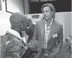  ?? KEVORK DJANSEZIAN/ GETTY IMAGES ?? That’s Brad Pitt with a name tag with Cynthia Erivo at the Oscars nominees lunch.