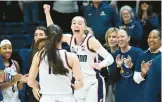  ?? CLOE POISSON/SPECIAL TO THE COURANT ?? Uconn guard Paige Bueckers cheers for teammate Nika Muhl after Muhl was presented with a ball marking her 600th career assist before their game against Villanova on Wednesday in Storrs.