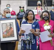  ?? ALYSSA POINTER / ALYSSA.POINTER@AJC.COM ?? Monteria Robinson (center) speaks about her late son, Jamarion Robinson, at a June news conference at the Georgia State Capitol. He was shot at 76 times in 2016 by a fugitive task force made up of local law enforcemen­t and federal authoritie­s.