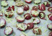  ?? MELISSA D’ARABIAN VIA AP ?? This photo shows Roasted Radishes With Green Goddess Dressing, in Bethesda, Md. The recipe tops plain roasted radishes with a quick green goddess dressing made from Greek yogurt, lemon juice, dill and parsley.