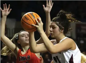  ?? (Arkansas Democrat-Gazette/Thomas Metthe) ?? Kirby’s McKenzie Jones (21) pulls down a rebound in front of Viola’s Sami McCandlis in last year’s Class 1A girls basketball state championsh­ip game. Jones, the title game MVP, returns to help the Lady Trojans defend their crown.