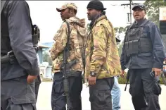  ??  ?? Armed police preparing to go on patrol outside their police station in the town of Wabag.