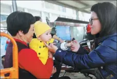  ?? HU MEIDONG / CHINA DAILY ?? Huang Yu-ching, an assistant from Taiwan, interacts with residents of Zhongshan community in Haicang district.