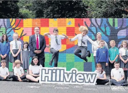  ??  ?? All smiles Pupils celebrate as headmistre­ss Jannette Black and education convener Paul O’Kane look on