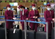  ?? (AP/Marcio Jose Sanchez) ?? Flight attendants wait to check in luggage Wednesday at Los Angeles Internatio­nal Airport. Despite warnings from public health officials, millions of Americans are traveling for the holidays.