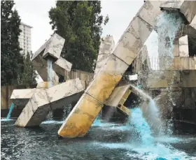  ?? Peter Hartlaub / The Chronicle ?? Blue water is flowing out of the Vaillancou­rt Fountain, which was installed along the Embarcader­o in 1971. The hue comes from an algae-killing product.