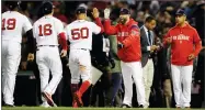  ?? AP PHOTO BY CHARLES KRUPA ?? Boston Red Sox celebrate after their 7-5 win against the Houston Astros in Game 2 of the ALCS Sunday, Oct. 14 in Boston.
