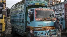  ?? ASSOCIATED PRESS ?? In this Sept. 22 file photo, a truck driver checks his phone at a parking lot in Kabul, Afghanista­n. With Afghan assets frozen in the US and the world reluctant to recognize the Taliban, the country’s banking system has come to a halt.