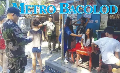  ?? BACOLOD CITY POLICE OFFICE / FACEBOOK ?? Officers from Police Station 3 in Bacolod City try to gather students of the Domingo Lacson National High School outside a store for a dialogue on the ill effects of illegal drugs on Friday, Feb. 9. Youths are considered by government antidrug...