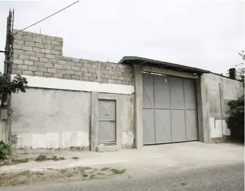  ??  ?? Ferdinand Jhon Santos was last seen alive at this trucking compound in Cavite, Philippine­s.