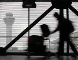  ?? NAM Y. HUH AP ?? A traveler walks through Terminal 3 at O'Hare Internatio­nal Airport in Chicago.
