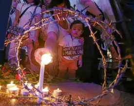  ?? —NIÑO JESUS ORBETA ?? Crowds gathered outside the parish light candles for the victims of martial law atrocities under the Marcos dictatorsh­ip and of the killings linked to President Duterte’s drug war.