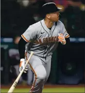  ?? TED S. WARREN — THE ASSOCIATED PRESS ?? Giants catcher Buster Posey watches his solo home run during the third against the Seattle Mariners on Friday.