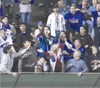  ?? GETTY IMAGES ?? Fans try to catch a two-run homer hit by Jason Heyward in the first inning Wednesday.