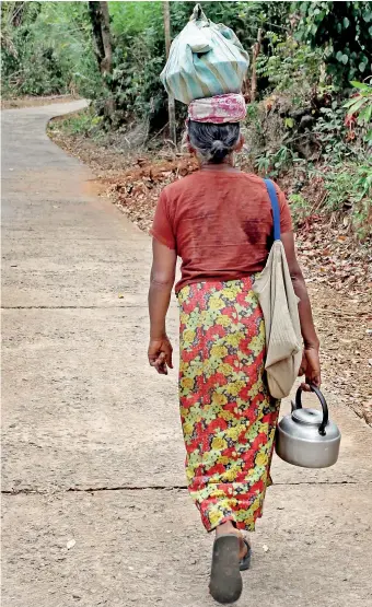  ??  ?? File picture of a villager returning to her village.