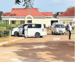  ?? RUDDY MATHISON PHOTO BY ?? Crime-scene investigat­ors process a section of Meadowrest Memorial Gardens in St Catherine following Tuesday’s deadly gun attack.