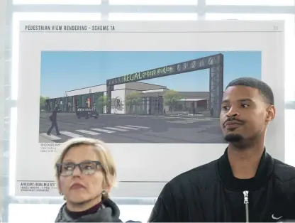  ?? TYLER PASCIAK LARIVIERE/SUN-TIMES ?? Two people stand next to a rendering of Regal Chicago Studios during a ground-breaking ceremony at the future site of Regal Mile Studios in a lot at 7824 South Chicago Avenue.